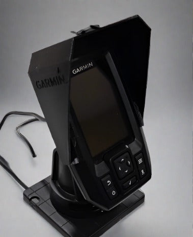 A black Garmin Striker 4 Plus GPS device with a sunshade/splashguard attached to it.