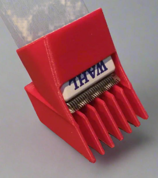 Red brush with bristles attached to a white plastic object on a gray surface