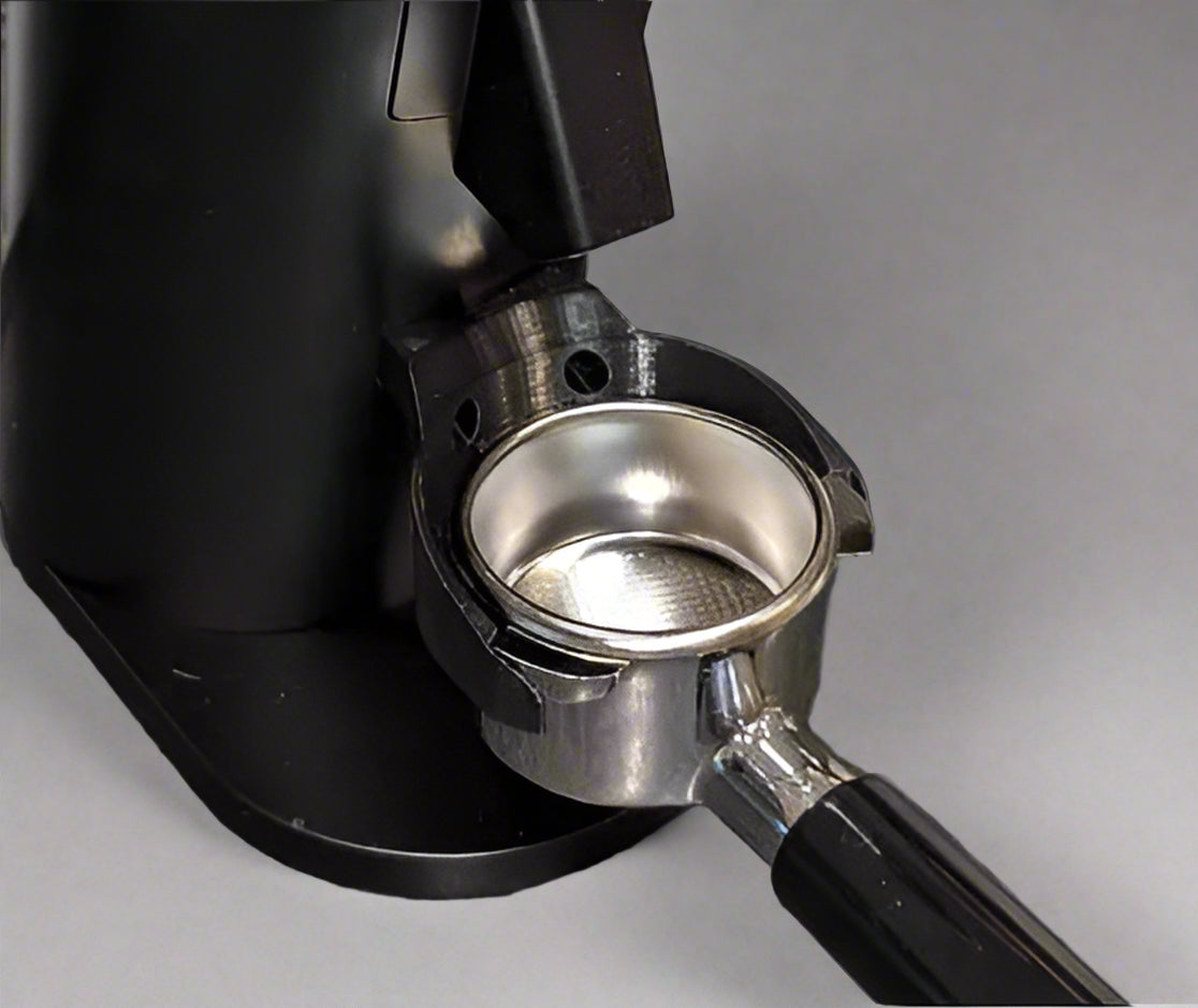 Black and silver coffee grinder on a gray countertop